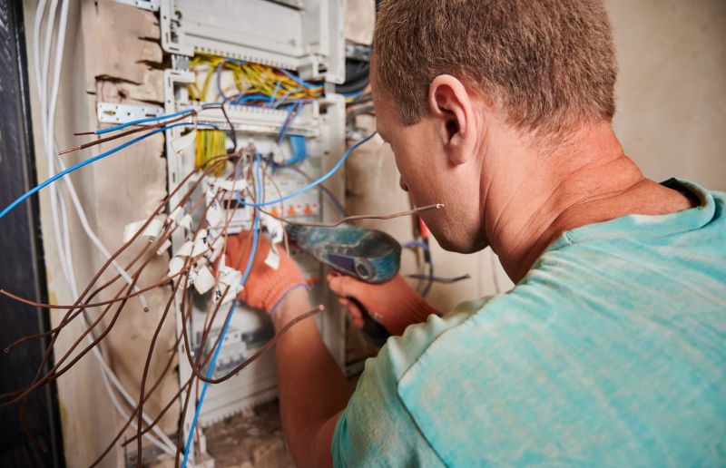 Electrician Working on Panel